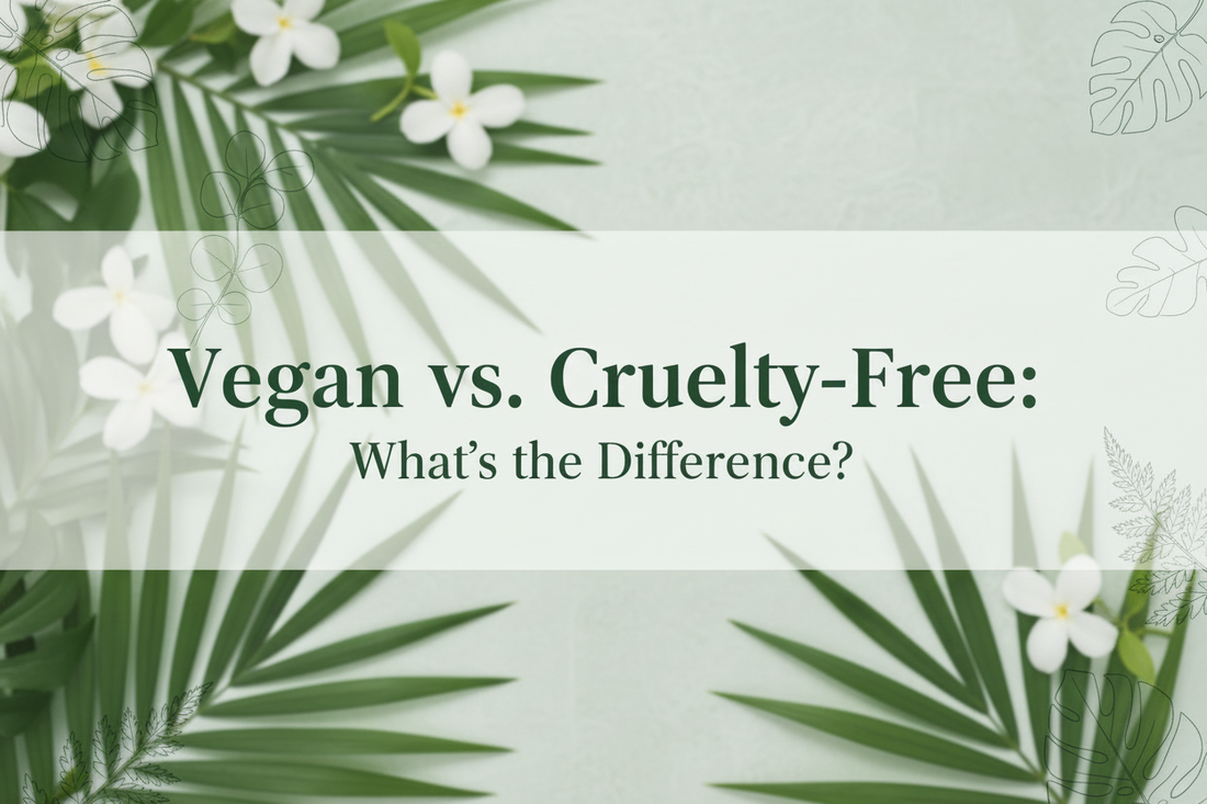 Lush green tropical leaves and white flowers on a sage green background with the text "Vegan vs. Cruelty-Free: What's the Difference?" — a clean beauty blog post by BodyWell1