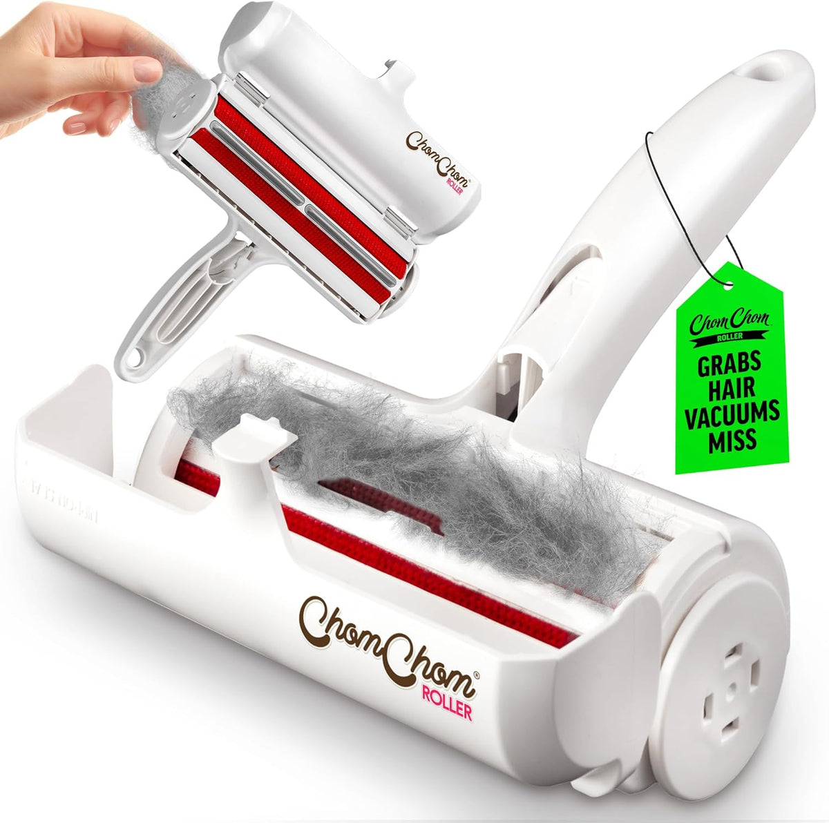 A white CharmChom Hair Vacuum Roller shown on a white background, with a hand holding a smaller matching roller above it and gray hair/floss material inside the larger roller. A green hanging tag reads 'CharmChom' and 'GRABS HAIR VACUUMS MISS'.