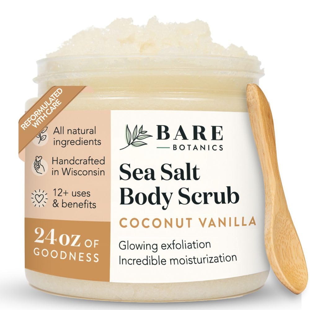 Jar of Bare Botanics Sea Salt Body Scrub with a wooden spoon on a white background