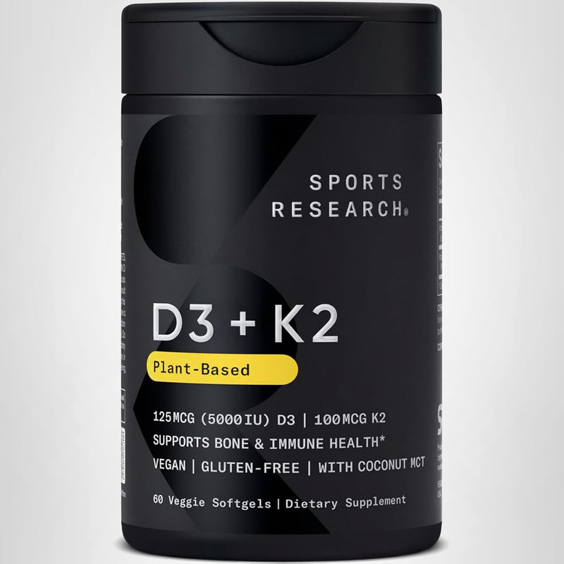 Black supplement bottle labeled 'D3 + K2' by Sports Research on a light gray background