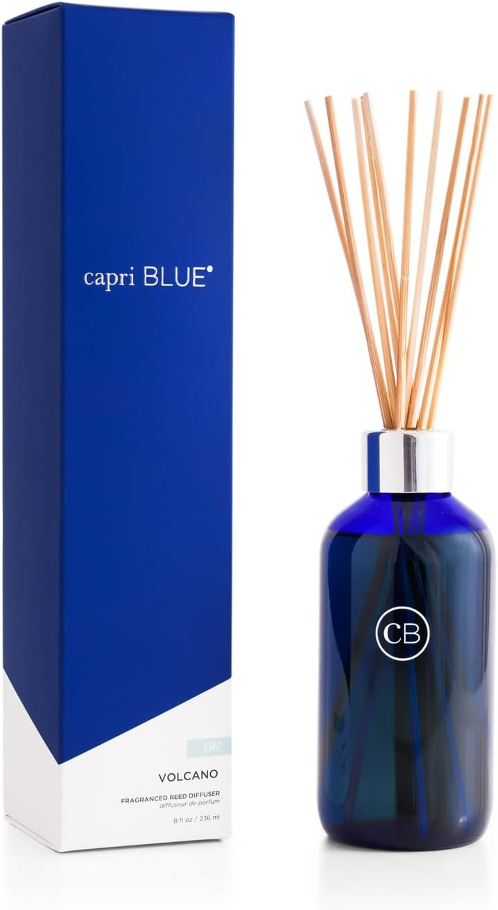 Capri Blue Volcano Reed Diffuser Set with cobalt blue glass bottle, natural reed sticks, and blue gift box on white background