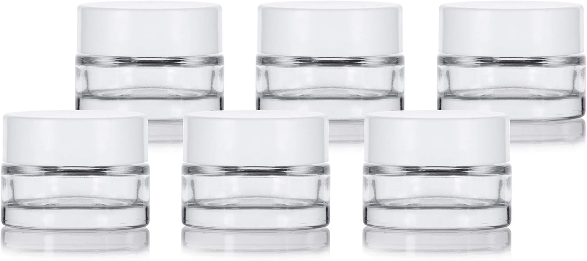 Six JUVITUS clear glass cosmetic jars with white lids on white background — 0.25 oz thick wall glass jars for DIY blush and clean beauty