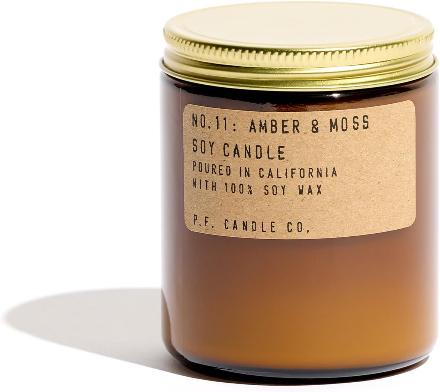 P.F. Candle Co. No.11 Amber & Moss soy candle in amber glass jar with gold lid and kraft paper label on white background
