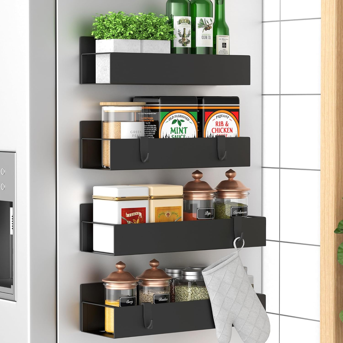 Black magnetic shelves on a refrigerator side holding spice jars and kitchen items
