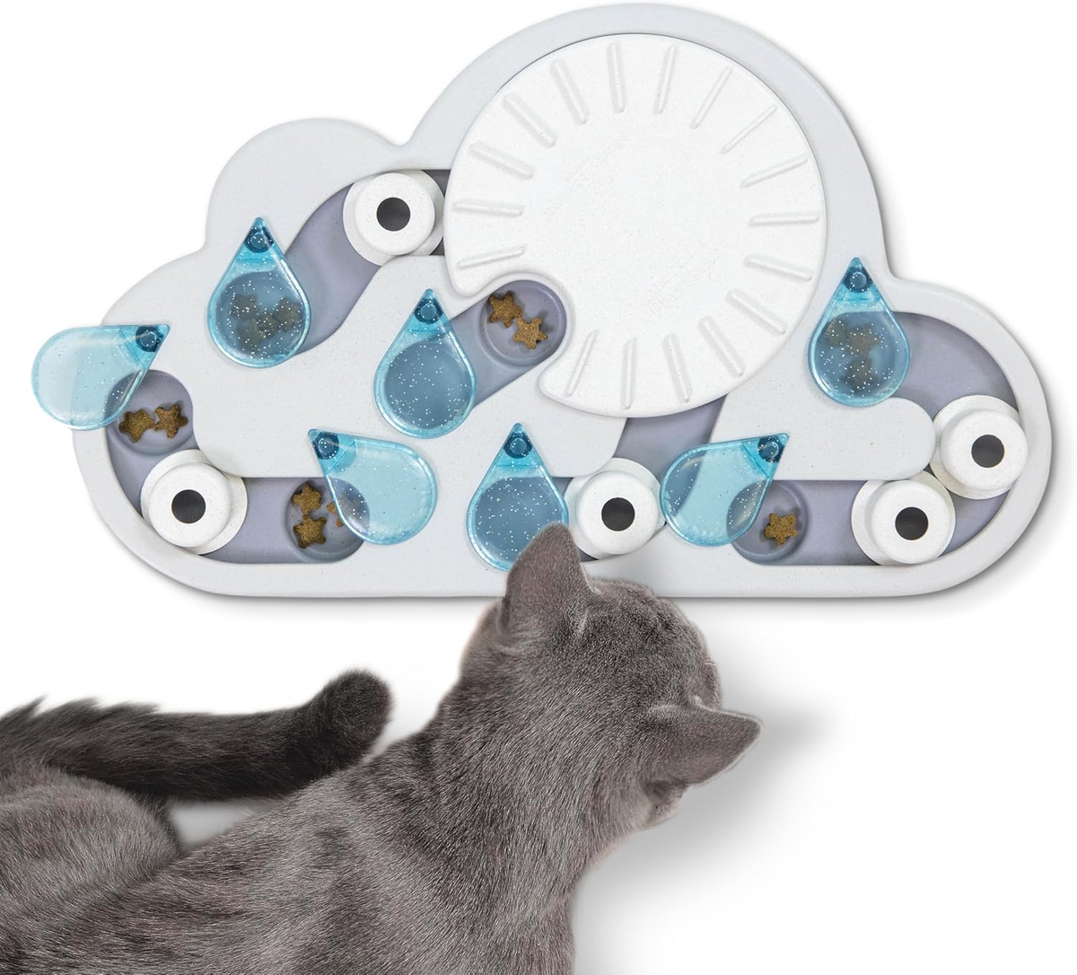 Gray cat exploring the Catstages Nina Ottosson Rainy Day Puzzle & Play with blue raindrop sliders and hidden treats on a white background.