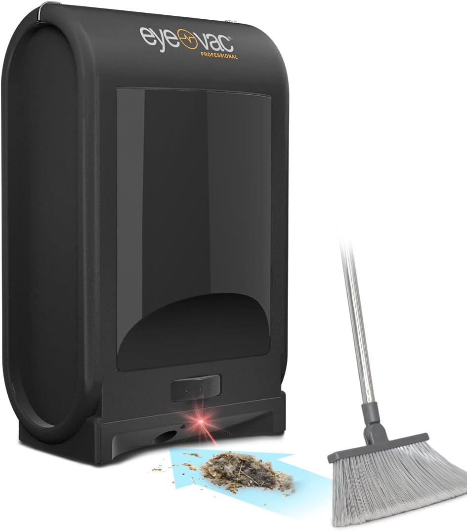 Black EyeVac Pro automatic dustpan vacuum beside a broom and floor debris on a white background; broom not included.