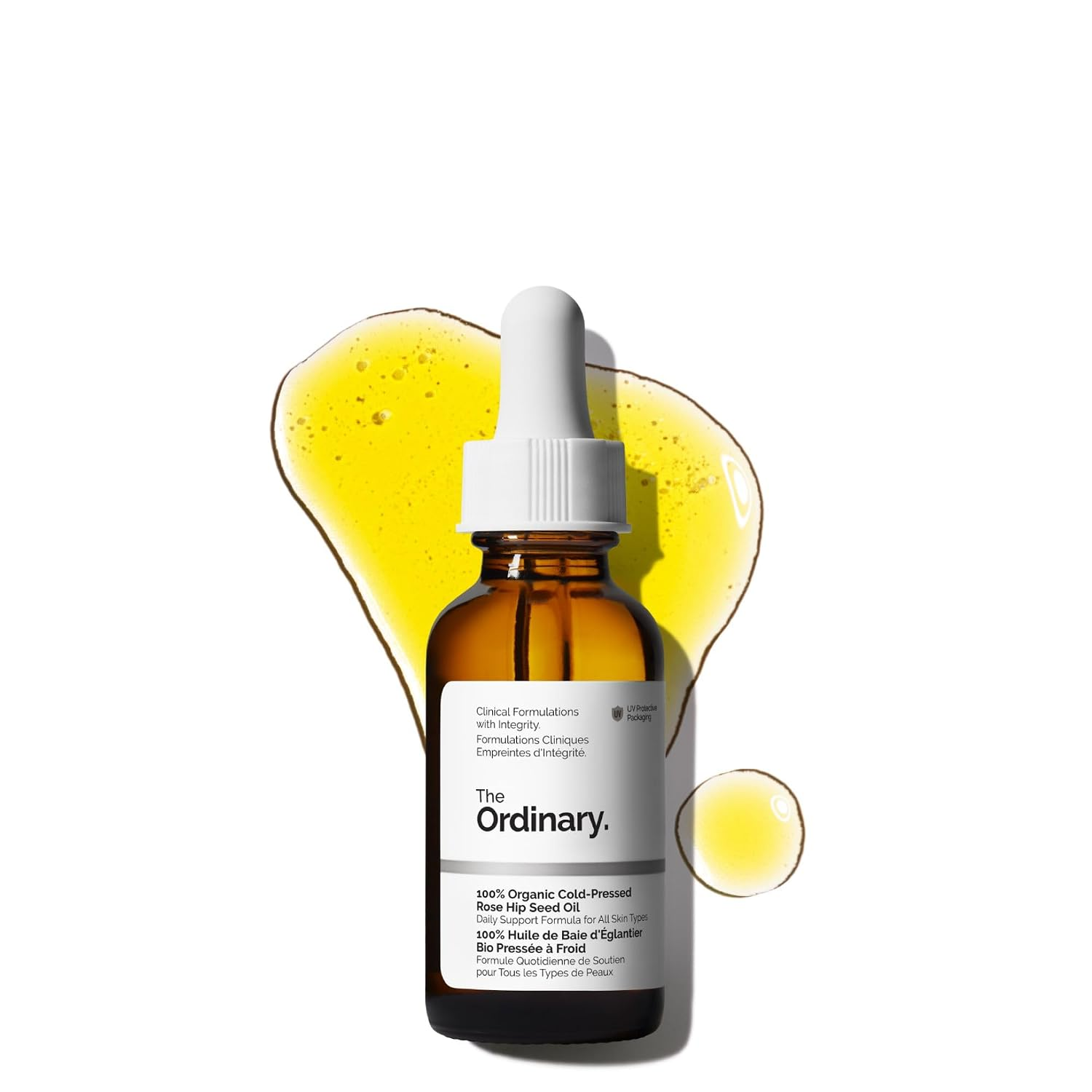The Ordinary 100% Organic Cold-Pressed Rose Hip Seed Oil in an amber glass dropper bottle with golden yellow oil swatch on white background