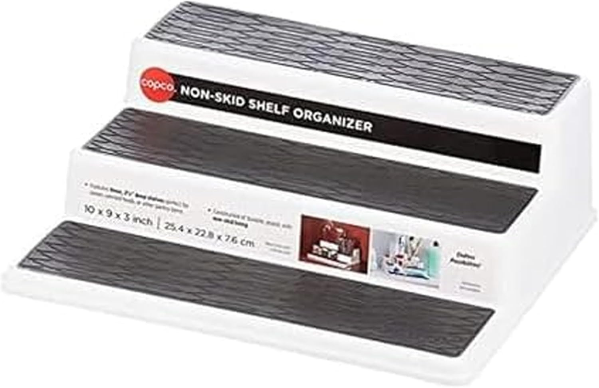Copco three-tier non-skid shelf organizer with white base and gray textured shelves, shown with its product packaging.