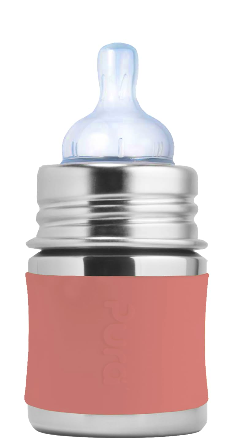 Pura Kiki 5 oz stainless steel infant bottle with a silicone nipple and soft coral sleeve on a clean white background.