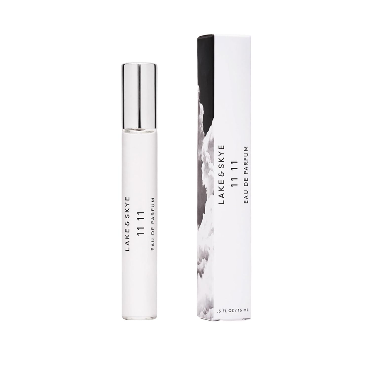 Lake & Skye 11 11 Eau de Parfum Travel Spray — clear slim glass spray bottle with silver cap beside white and black cloud-print box, clean skin musk amber fragrance, 0.5 fl oz 15mL