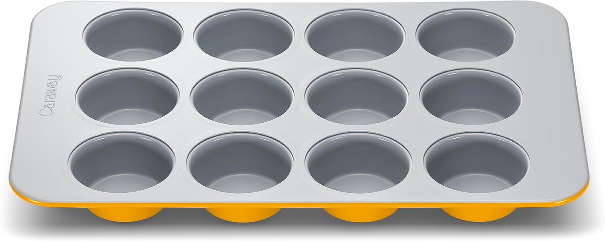 Caraway Non-Stick Ceramic 12-Cup Muffin Pan in marigold yellow and gray ceramic coating