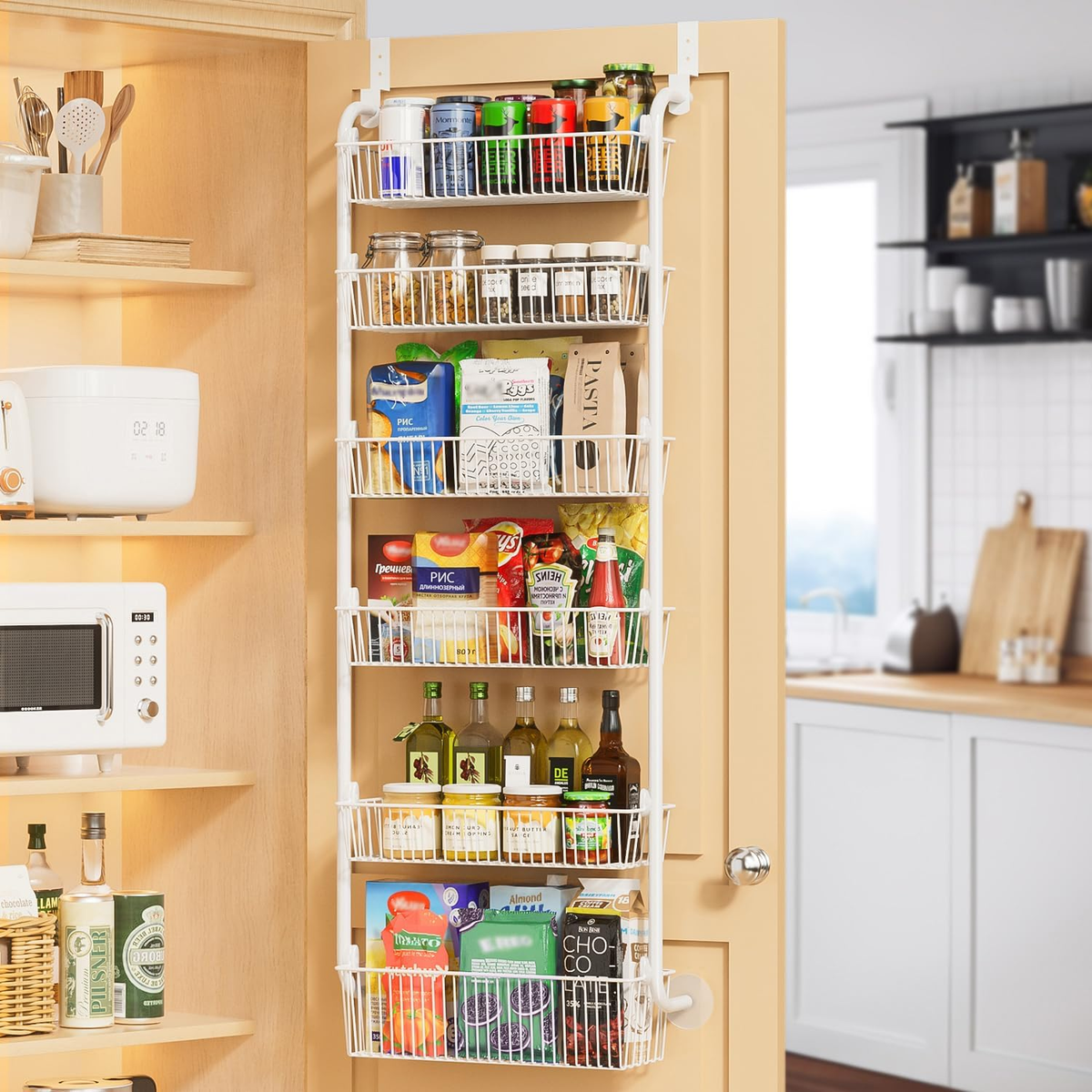 White six-basket Delamu over-the-door pantry organizer holding spices, snacks and bottles on a pantry door.