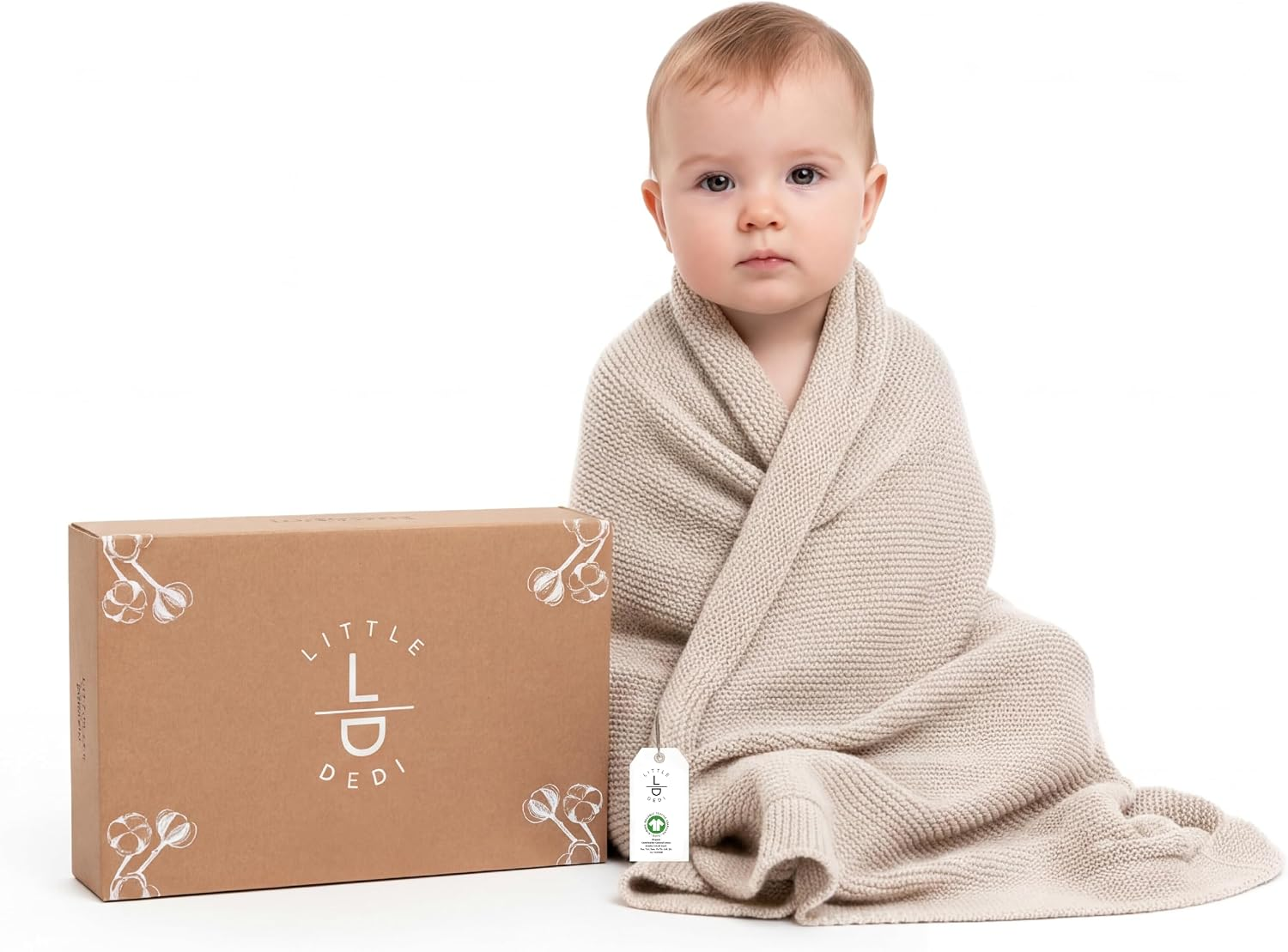 Little Dedi Organic Cotton Baby Knit Blanket in Stone with gift box and baby wrapped in blanket on white background
