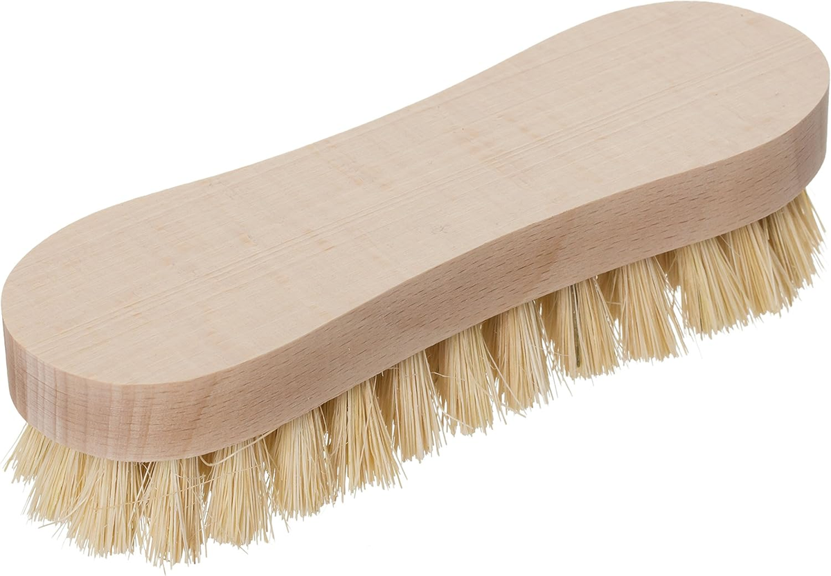 Peanut-shaped untreated beechwood scrub brush with pale tampico fiber bristles on a white background