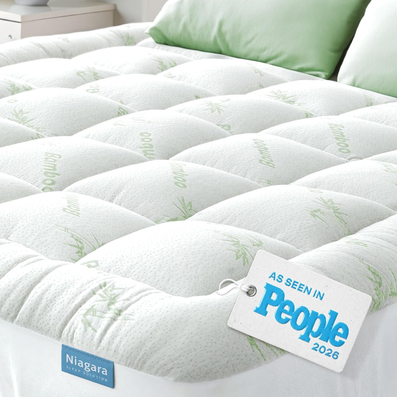Niagara Sleep Solution bamboo mattress topper on a bed with sage green pillows — ultra soft plant-derived bamboo rayon pillow top for naturally cooling sleep, As Seen in People 2026