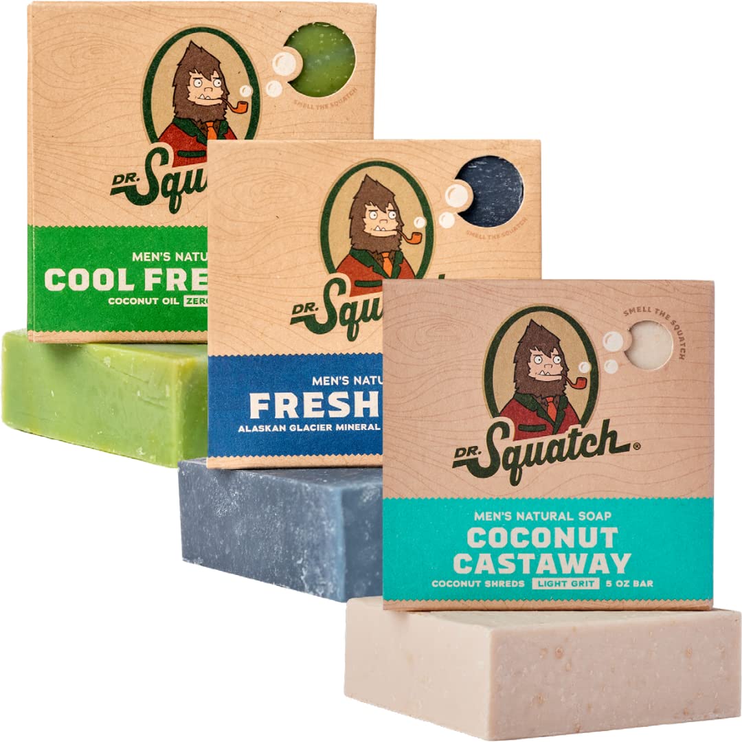 Three bars of Dr. Squatch soap with their packaging on a white background