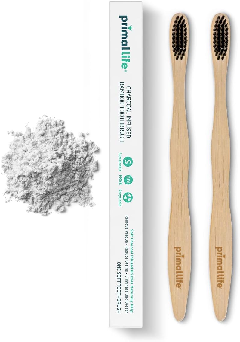Two bamboo toothbrushes with charcoal-infused bristles and packaging on a white background.